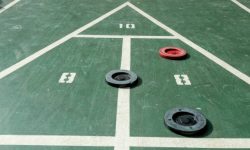 This picture shows shuffleboard pucks and a court. This court was found at a resort hotel.